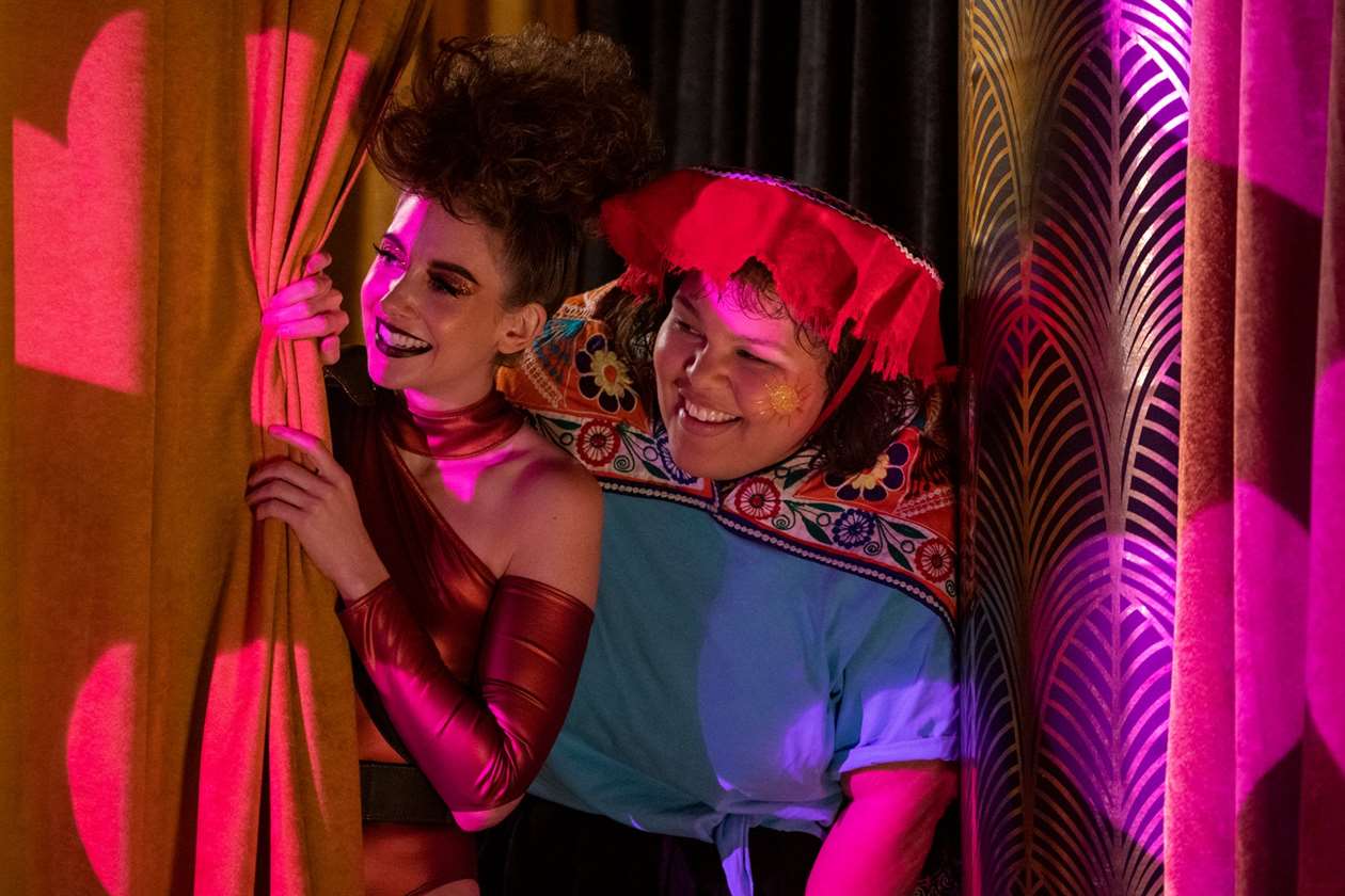 Zoya the Destroya và Machu Picchu nhìn ra từ sau bức màn trong buổi biểu diễn GLOW ở Las Vegas, trong Phần 3. 